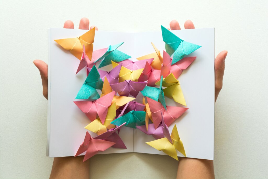 Origami butterflies in pink, purple, blue and yellow.