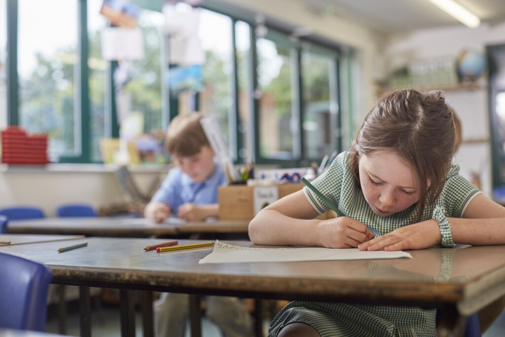 Children writing in the classroom