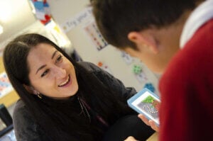 Teacher smiling at pupil