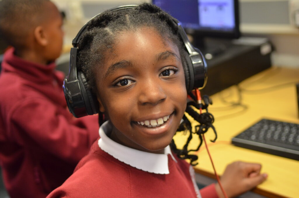 pupil wearing headphones for ICT lesson