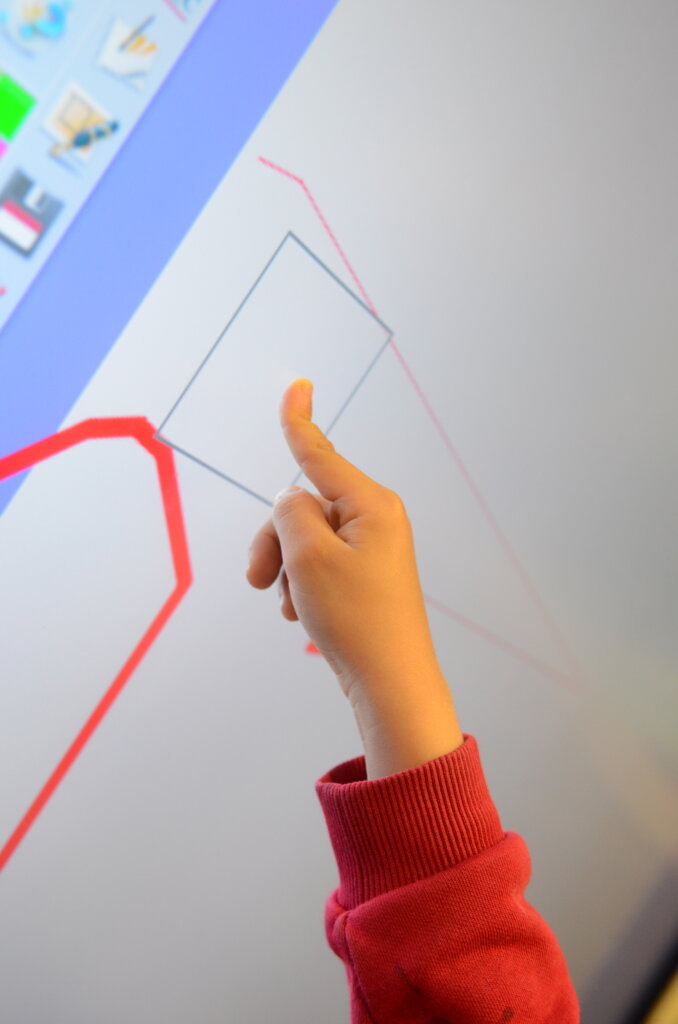 pupil finger plays with interactive whiteboard