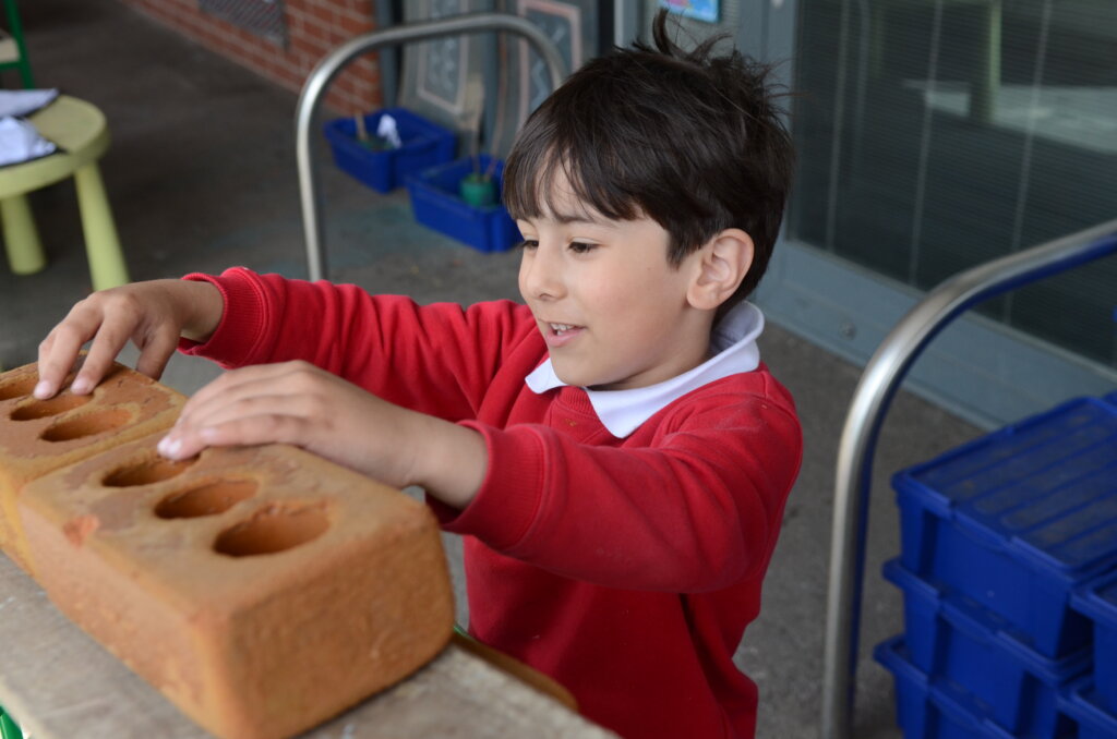 boy pupil playing with bricks