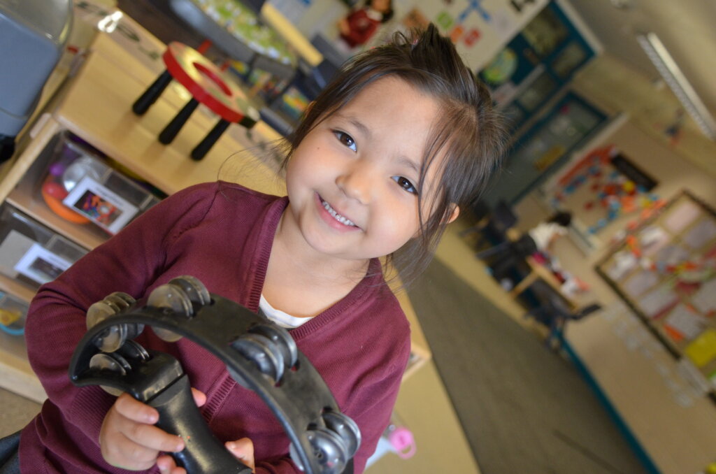 Child playing tambourine