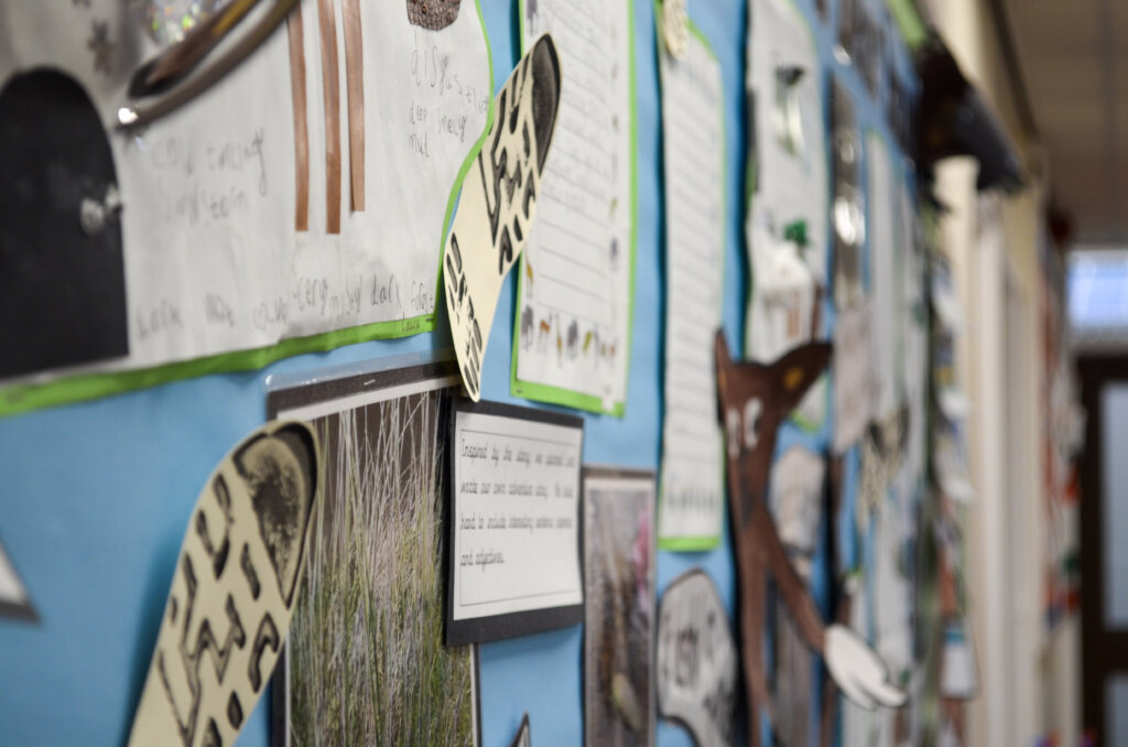 Children's work displayed on the wall.