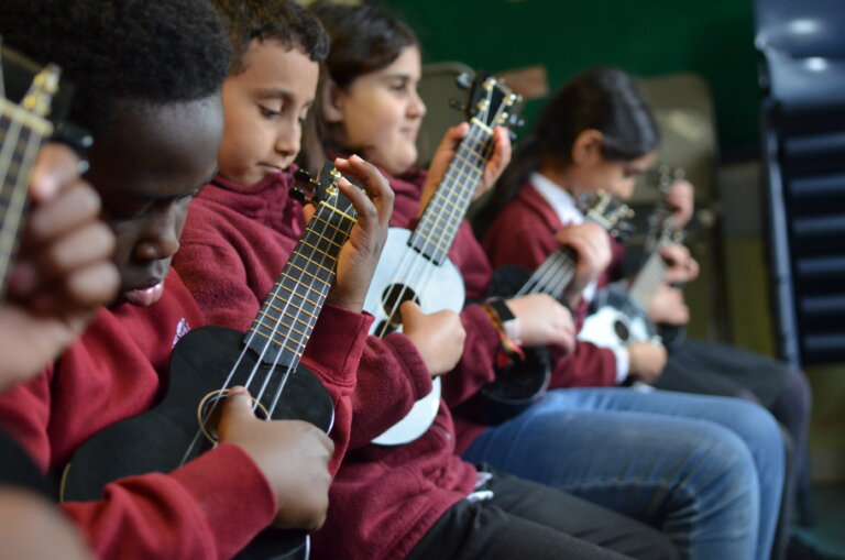 pupils learning to play ukulele