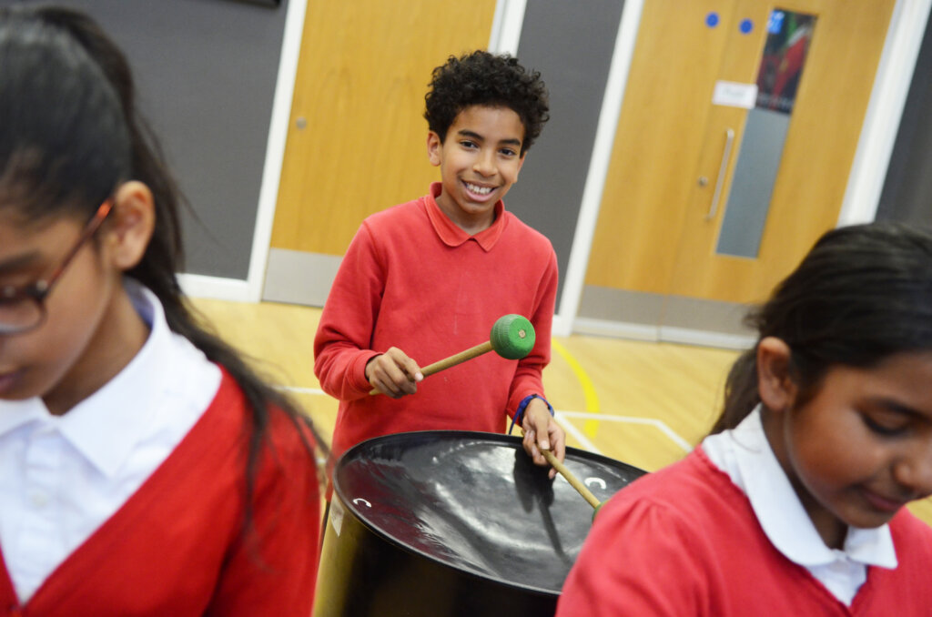 boy pupil plays steel drum