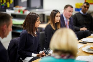 Teachers sitting around a table at a meeting.