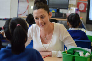 Teacher smiling at pupil