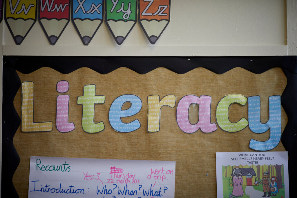 A classroom display that showcases children's work under the Literacy banner.