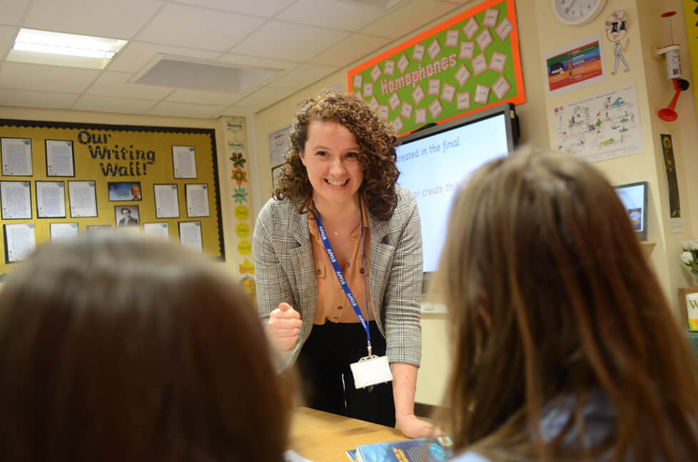 Teacher smiling at pupils