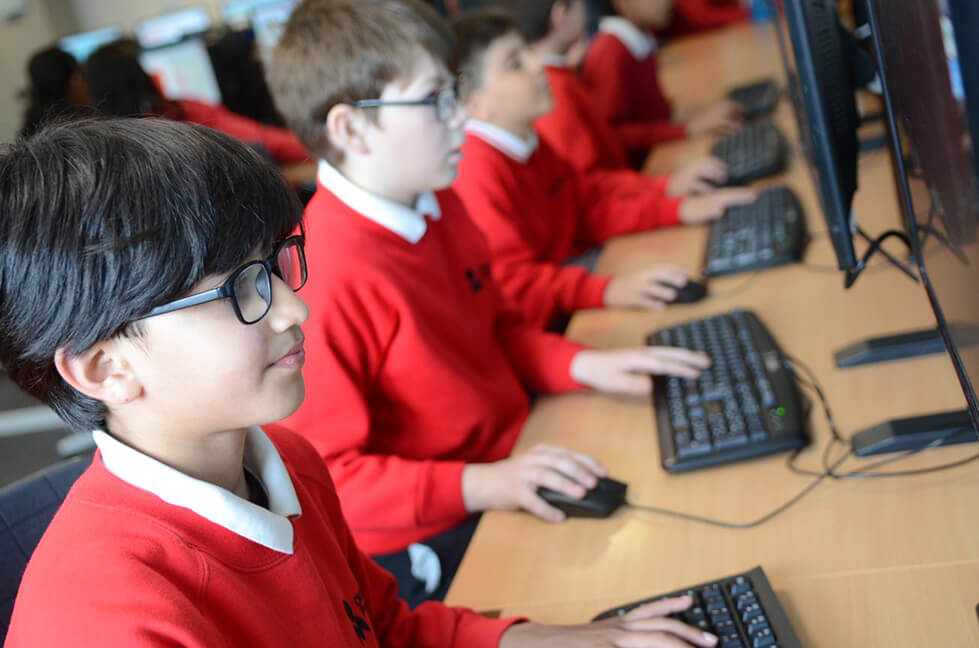 pupils sitting at computers IT lesson