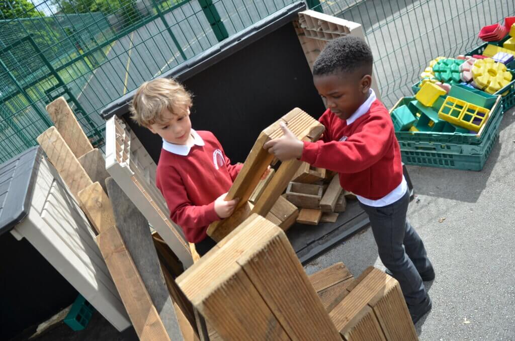 2 boy pupils playing with blocks
