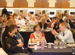 Delegates talking and making connections in the conference hall where the SIMS event took place.