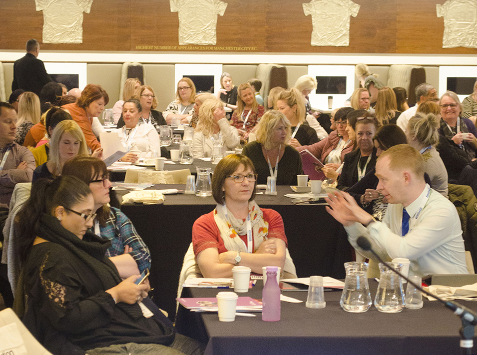 Delegates talking and making connections in the conference hall where the SIMS event took place.