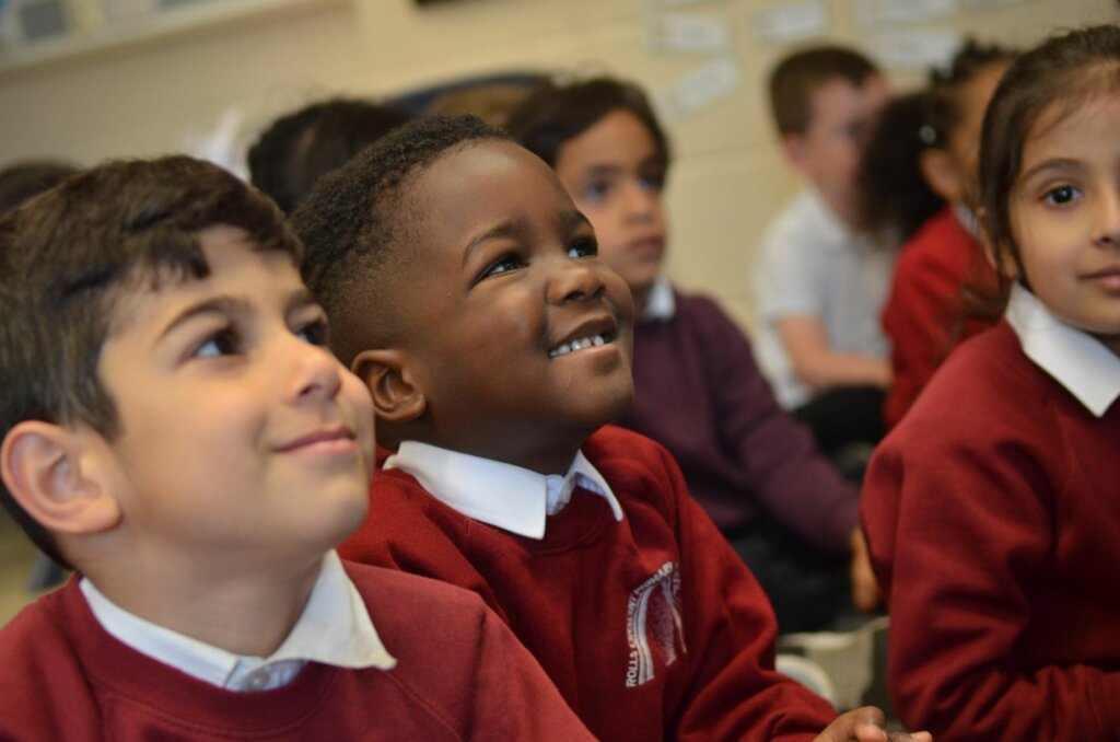 Early years pupils smiling.