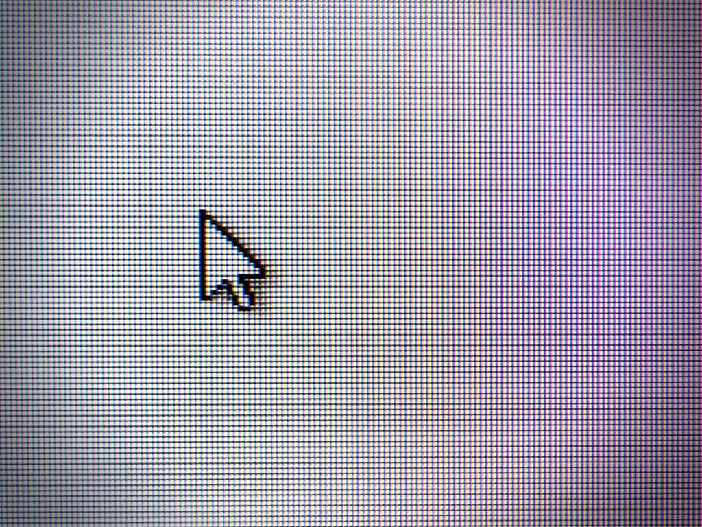 Close up of a computer screen with a mouse pointer arrow