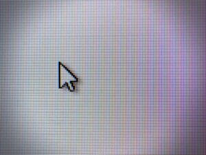 Close up of a computer screen with a mouse pointer arrow