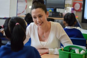 A teacher smiling at a pupil.