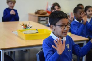 Children counting on their fingers in the classroom.