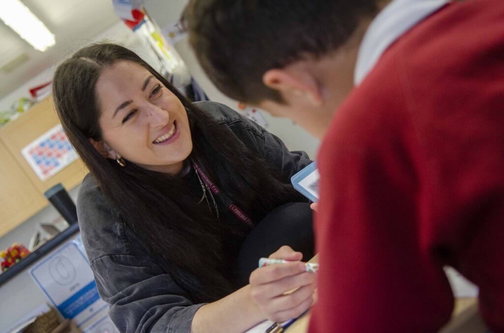 A teacher smiling at a student
