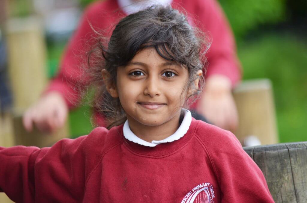 A school girl smiling in the playground