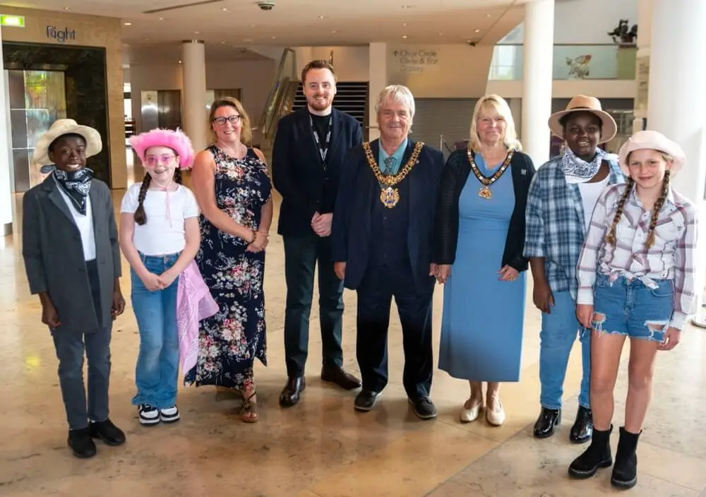 From left to right, Rachel Foster, One Education Director of HR & Education Strategy, Adam Cooke, Head of One Education Music, and Lord Mayor of Manchester, Cllr Paul Andrews, and Lady Mayoress, Karen Andrews, with children from Manchester schools at the Big 'Country' Sing 2024.