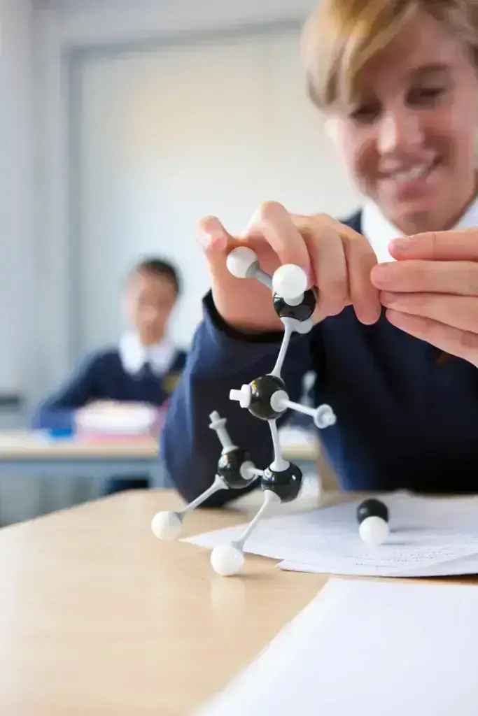 a-portrait-close-up-shot-of-a-pupil-buliding a chemistry model