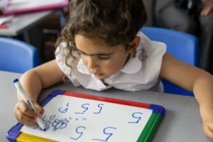 girl draws on whiteboard