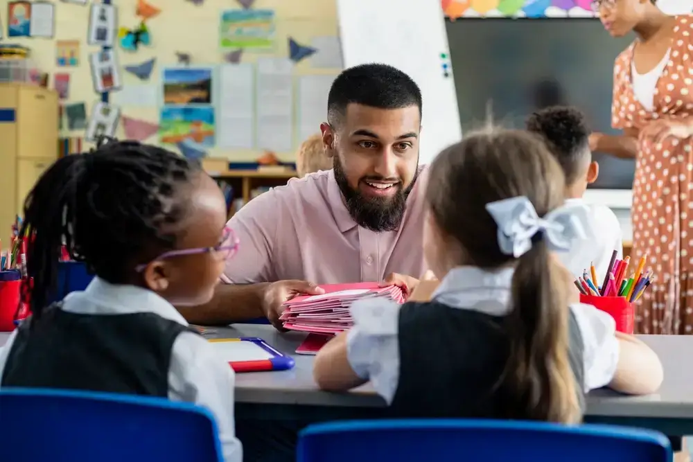 teacher speaking to two pupils