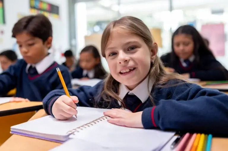 pupil holds pencil white writing