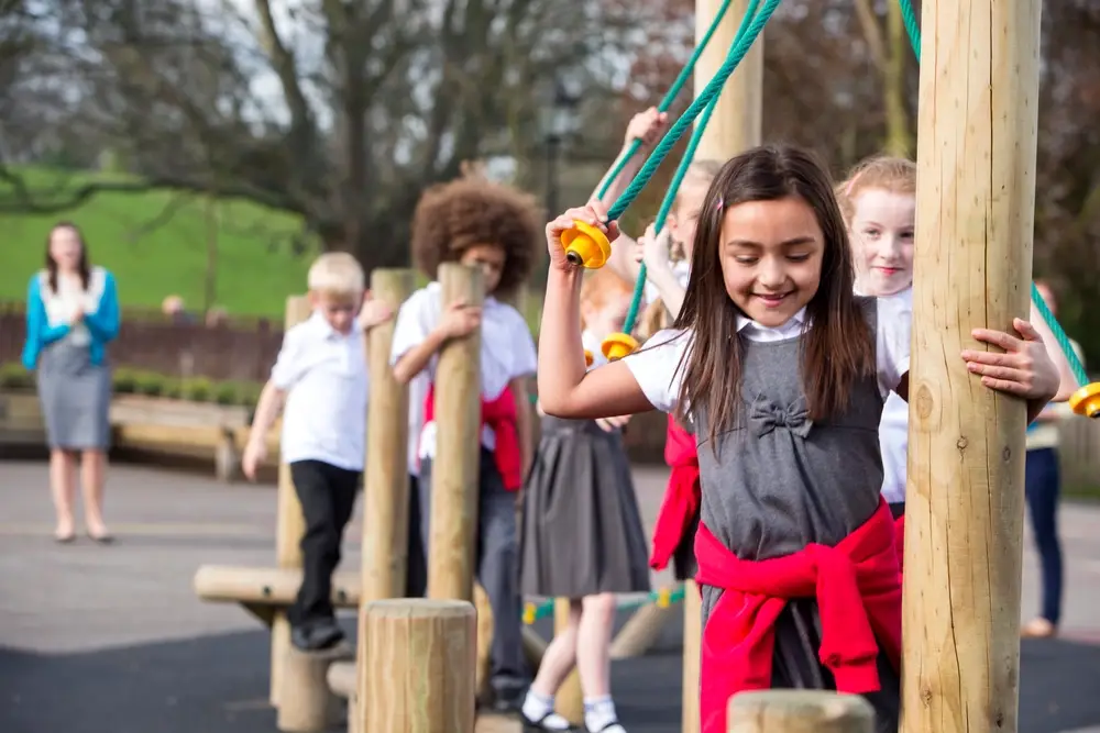 pupils play on outdoor climbing equipment