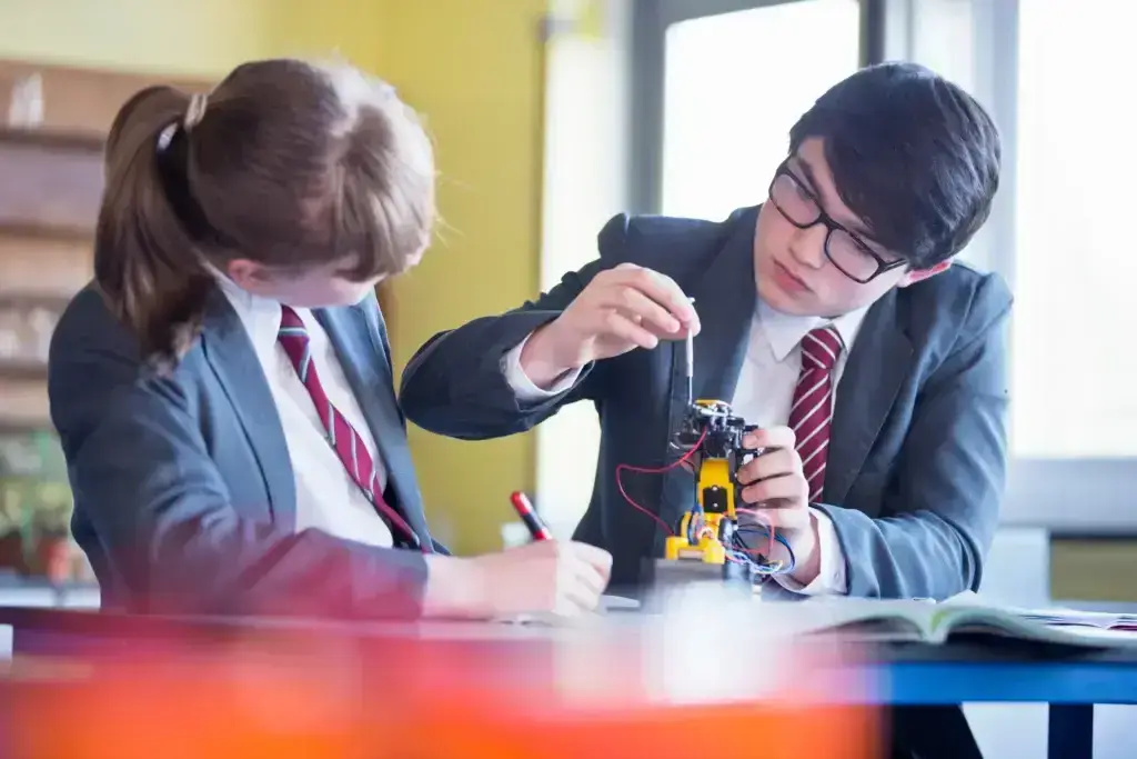 medium-shot-of-high-school-students-assembling-a-robot