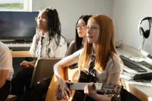 pupil play guitar in lesson