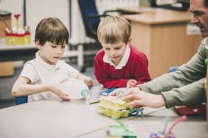 pupils playing in class with a teacher