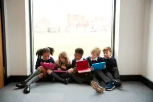 pupils sit by window and chat