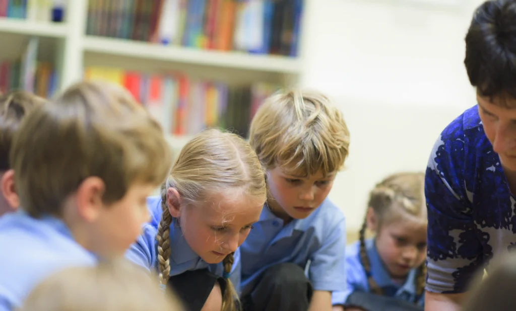 pupils watch teacher demonstrate