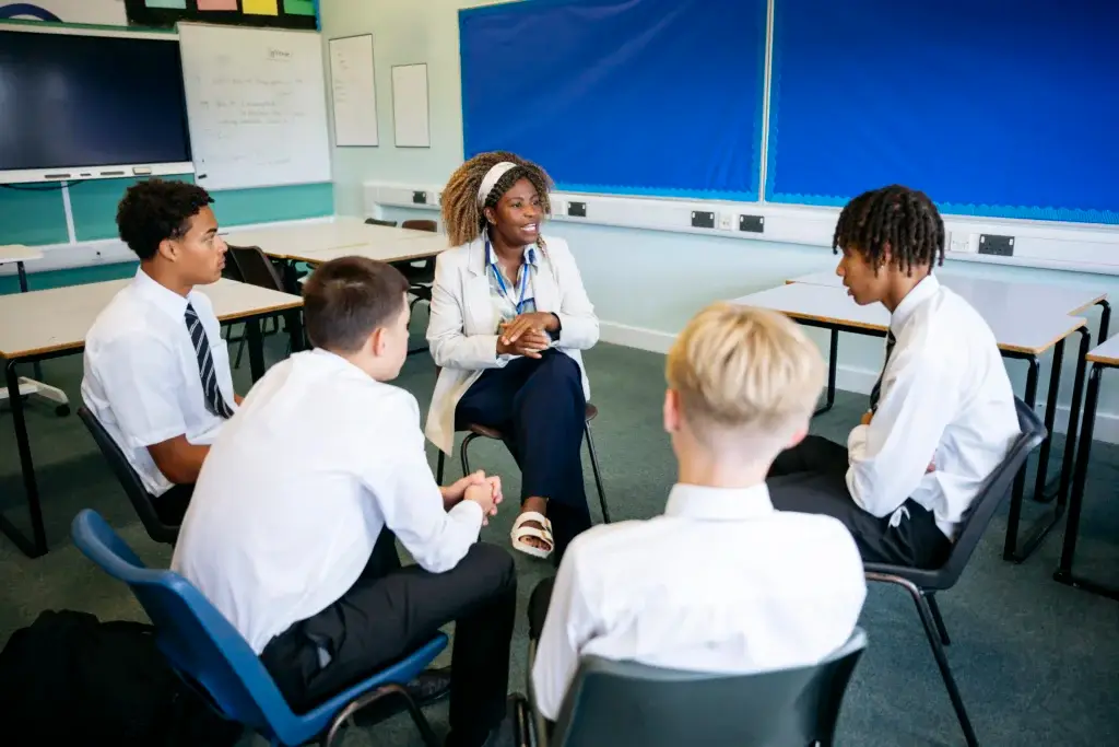 teacher talks t group of boys
