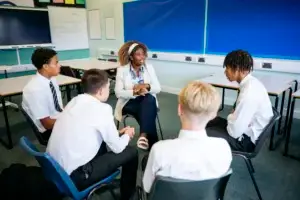teacher talks t group of boys
