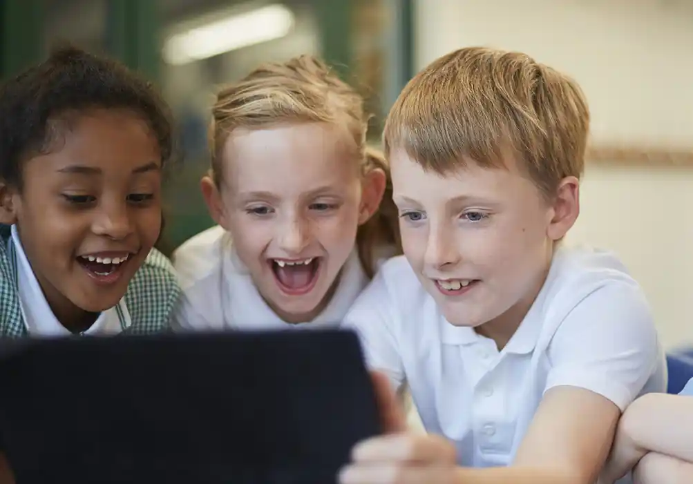 smiling children looking at a tablet screen togeth 2026 03 25 02 18 42 utc copy