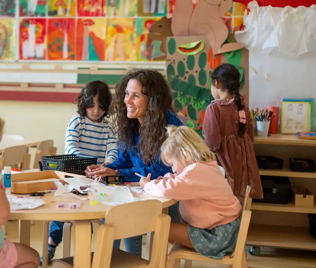 children and teacher at an activity table 2026 03 25 02 55 54 utc