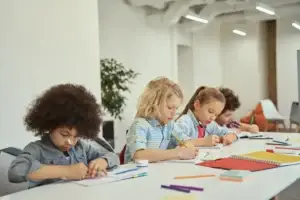 children studying at a white table in classroom 2026 01 09 00 26 58 utc