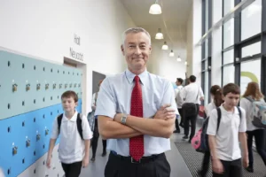 portrait of male teacher with arms folded in schoo 2026 01 09 09 40 10 utc