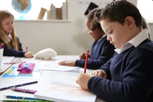 pre teen school boy with down syndrome sitting at 2026 03 10 03 54 12 utc
