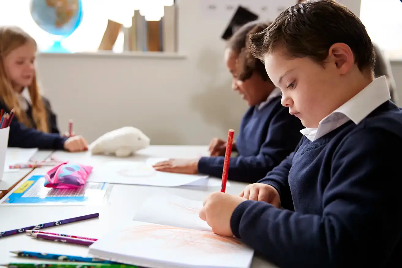 pre teen school boy with down syndrome sitting at 2026 03 10 03 54 12 utc