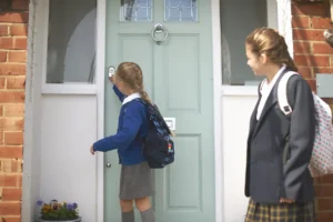 school girl and teenage sister closing front door 2026 01 09 09 20 44 utc